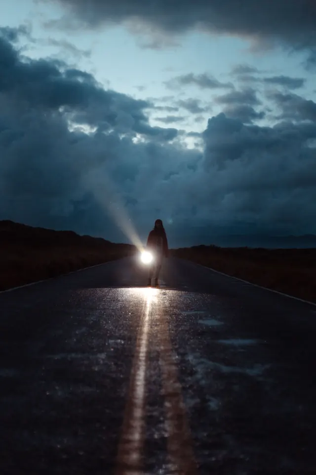 A figure walking at dusk