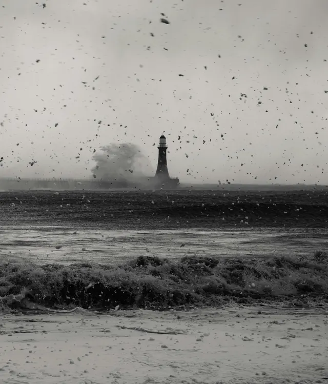 A lighthouse in a storm, black and white